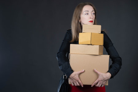 woman with bewildered look. girl with many boxes is confused. Boxes as metaphor for commodity...