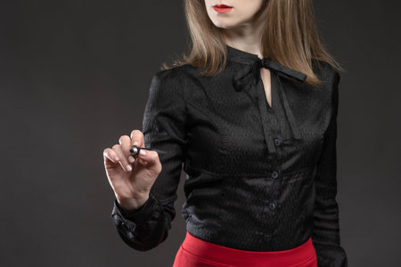 Business woman with marker. girl in stylish business clothes. Concept - she draws something on...