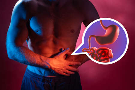 Healthy intestines. Man with healthy intestine and feel comfortable. Dysbiosis and colic prevention. Human anatomy and physiology. Intestine mockup against the background of man figure.の写真素材