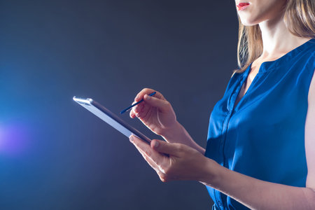 Businesswoman with tablet. Tablet computer and stylus in hand. Girl is working with some kind...