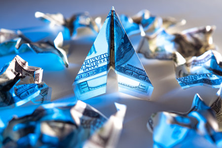 Dollars. Money. A plane from a bill next to crumpled money. Concept - recovering of the USA economy. The revival of the economy after the crisis. Aircraft as a sign of economic recovery.の写真素材