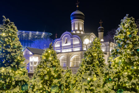 Moscow. Russia. Orthodox church in the park Zaryadye. Temple of the Great Martyr George the Victorious of the Protection of the Virgin. Christmas trees near temple. Russian church on Christmas nightの写真素材