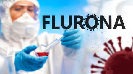 Flurona coronavirus variant. Flurona Covid-19 mutation. Coronavirus SARS-CoV-2 Omicron infection. New strain of Flurona label. Blurred researcher with test tube on blue. Flask of Infectious Bloodの写真素材
