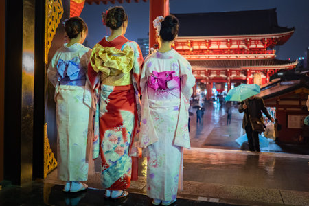 Tokyo. Japan Girls in kimono. Asakusa Street. Women admire the temple. Female kimono with flowers....