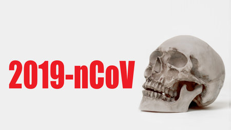 2019-nCoV logo next to a human skull. human skull on a light background.