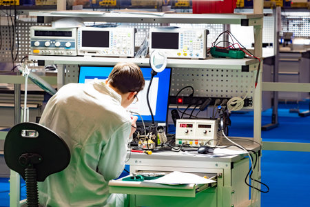 Man in a technology laboratory. Man with a soldering iron at the desk. Concept - modern inventor....