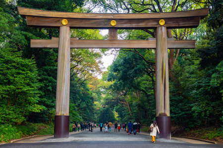 Japan. Meijijingu Gaien Park in Tokyo. Shinjuku Large wooden arch in a japanese park. Japanese gate. Tourists walk through the park in Tokyo. Tours in the cities of Japan. Sights of Tokyo.のeditorial素材
