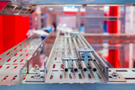 Channel for cable laying. Steel structural profile. Place for laying failures. Steel profile for laying wires. Electrical communications at the enterprise. engineering infrastructure.の写真素材