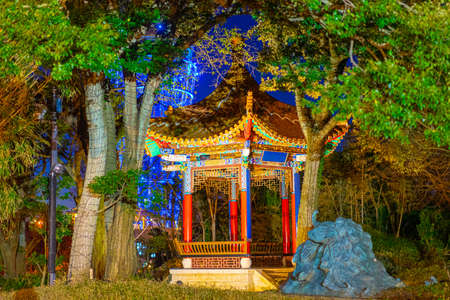 Japan. Enoshima Island. Japanese style gazebo. Surroundings of Tokyo. Attractions of Enoshima Island. Gazebo in the night park. Outdoor arbor in the middle of trees. Tourism in Japan.の写真素材