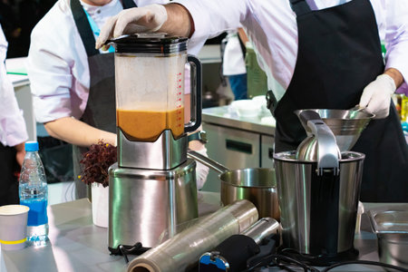 Work in a candy store. Confectioners make jam in a blender. Chefs work with Blender. Recipes using...