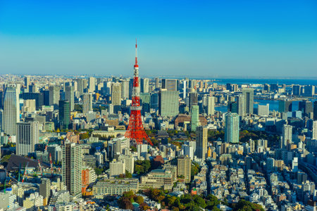Japan. Tokyo. TV tower Japan. Panorama of Tokyo view from a quadcopter. Red and white television tower rises above the city. Tokyo on the background of blue sky. Television tower in a Japanese cityのeditorial素材