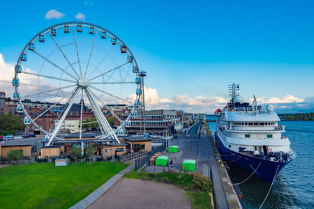 Helsinki. Finland. The motor ship at the promenade. Ferris wheel on the promenade. Tourist ferry arrived in Helsinki. Baltic Sea. Helsinki on a summer day. Cruise to Finland. Traveling by ship.のeditorial素材