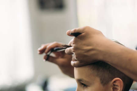 Little boy on a haircut in the barber.の写真素材
