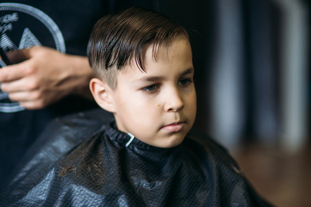 Little boy on a haircut in the barber.の写真素材