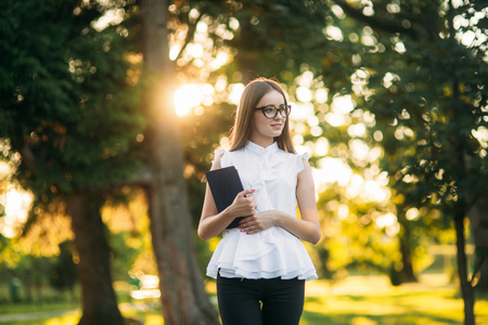 Business lady uses a tablet in the park during a breakの写真素材