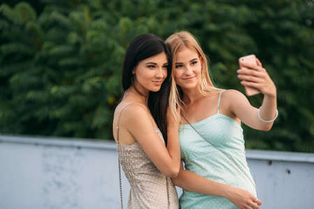 Models walk around the city and use Gadgets. Sunny day. Summer.の写真素材