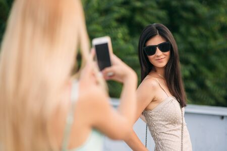 Models walk around the city and use Gadgets. Sunny day. Summer.の写真素材