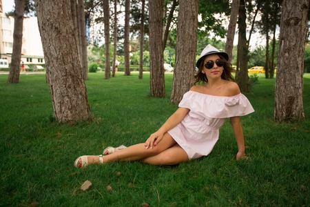 Beautiful girl in the park. Green grass and sunny weatherの写真素材
