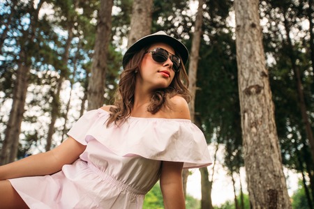 Beautiful girl in the park. Green grass and sunny weatherの写真素材
