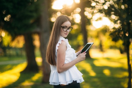 Business lady uses a tablet in the park during a breakの写真素材