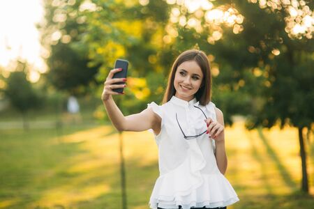 Business lady uses a tablet in the park during a breakの写真素材