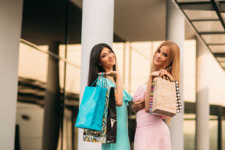 Beautiful girls go shopping. Sunny day. Summer.の写真素材