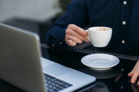 The young manager working on a laptop on coffe break. Lunch Break.の写真素材