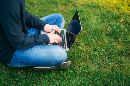 The young manager working on a laptop in the park. Lunch Breakの写真素材