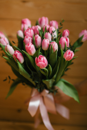 A bouquet of pink tulips in a beautiful crystal vase