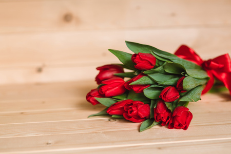 Red tulips on a wooden background.の写真素材
