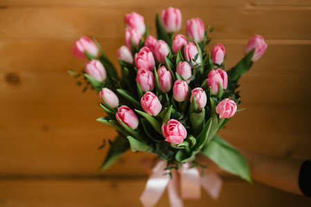 A bouquet of pink tulips in a beautiful crystal vaseの写真素材