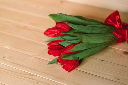 Beautiful Rustic background with Red Tulips. Colorful Card for Mothers Day, Birthday, International Womens Day March 8の写真素材