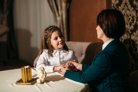 Mother and little daughter in the restaurantの写真素材