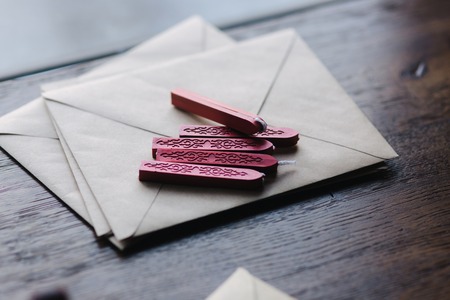 Man makes the stamp using sealing wax on the envelopeの写真素材