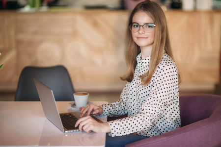 Business woman with laptop and phone in cafeの写真素材