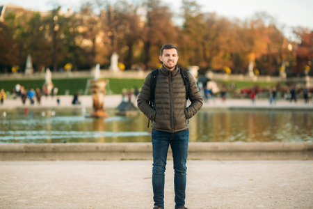 Handsome man with backpack posing for photographer in pakrの写真素材