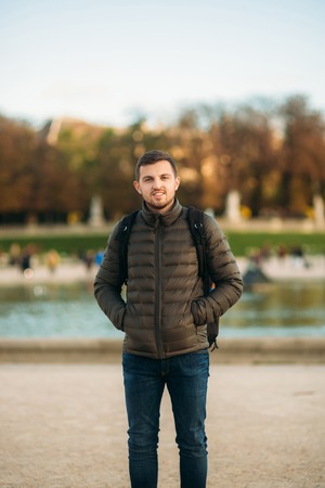 Handsome man with backpack posing for photographer in pakrの写真素材