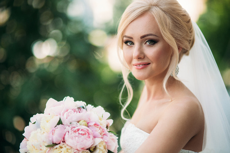 Portrait of a bride in a wedding dress. The bride dresses in the hotelの写真素材