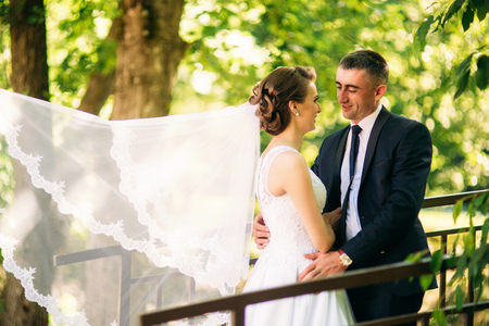 Young couple, bride and groom walking and enjoying their wedding day. Sunshine. Summerの写真素材