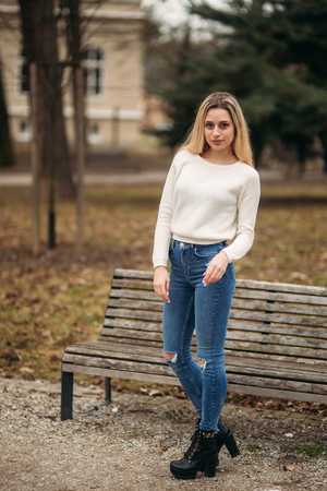 Blonde girl in the park in cloudy weatherの写真素材