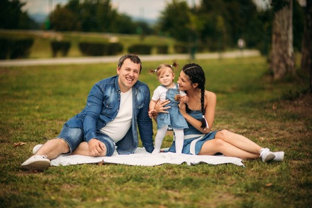 happy young family spending time outdoor on a summer dayの写真素材