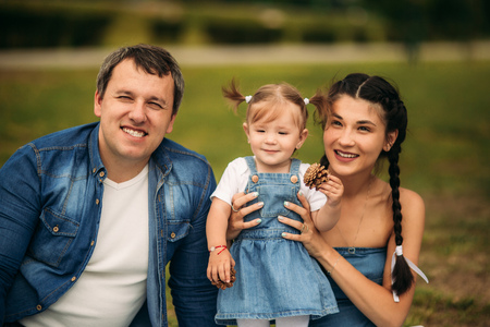 happy young family spending time outdoor on a summer dayの写真素材