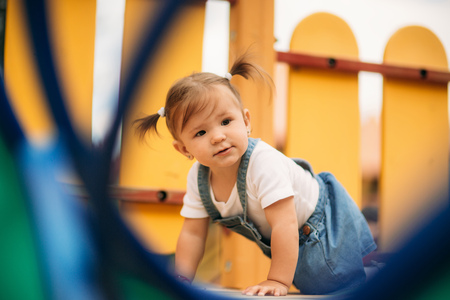Happy child walks in the park and playing in playgroundの写真素材