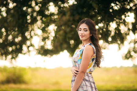beautiful girl stand near a large green tree. Love storyの写真素材