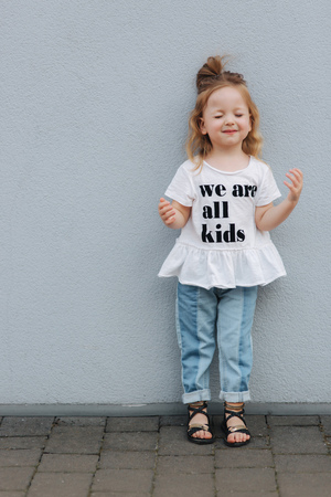 Funny little girl having fun in the city. we are all kidsの写真素材