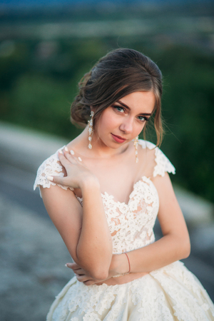 Teenage girl in wedding dress on city. Background town sunsetの写真素材