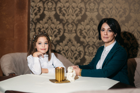 Mother and little daughter in the restaurantの写真素材