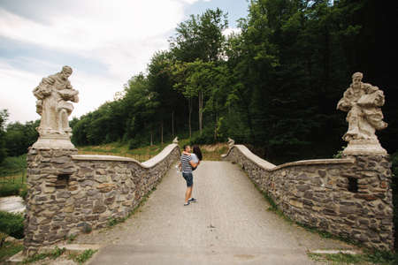 Young couple in love spending time together near the big old bridgeの写真素材