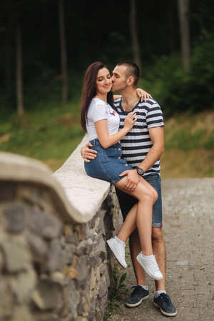 Young couple in love spending time together near the big old bridgeの写真素材