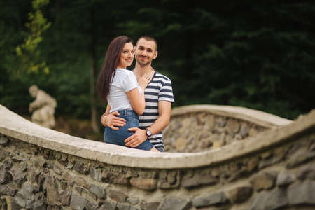Young couple in love spending time together near the big old bridgeの写真素材
